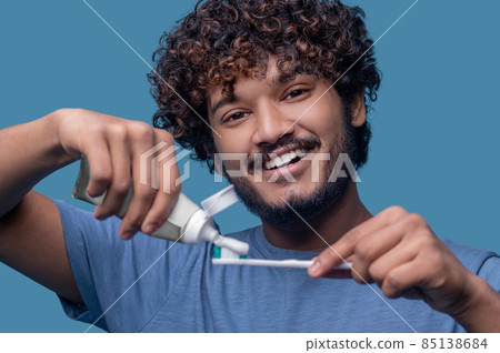 Joyous male looking at the camera before the tooth-brushing procedure 85138684