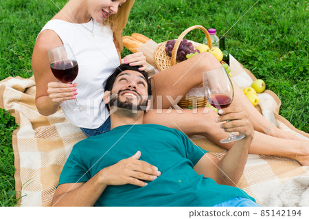 Boyfiend is relaxing on the lap of female 85142194