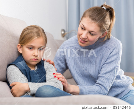 Mother comforts offended little daughter at home Mother comforts offended little daughter at home 85142446