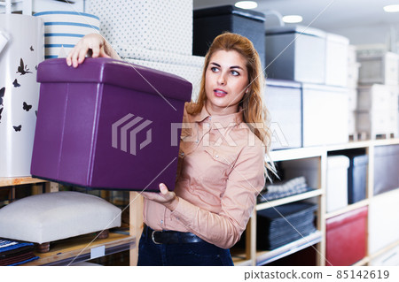 Girl choosing new comfortable ottoman Girl choosing new comfortable ottoman 85142619