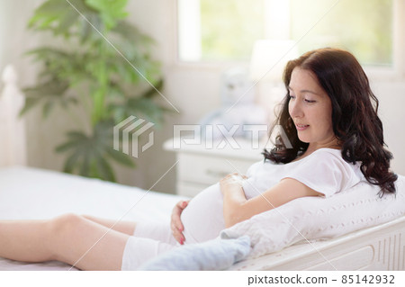 Pregnant woman at home. Young expecting mother. 85142932