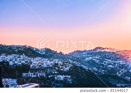 Christmas fantasy landscape and winter wonderland background. Snowy mountain village by the sea at holiday evening 85144017