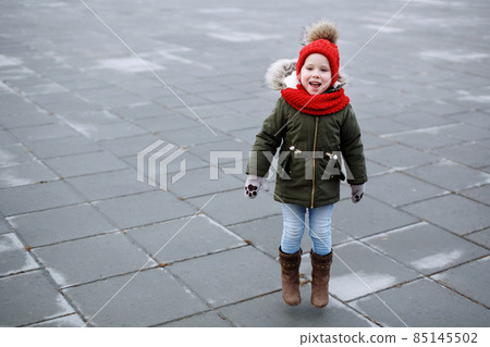 Sweet little funny girl in trendy outfit walking and dancing on the street, having fun, jumping Sweet little funny girl in trendy outfit walking and dancing on the street, having fun, jumping 85145502