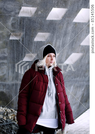 Young thoughtful millennial hipster teenager female portrait, blonde young woman standing outdoors Young thoughtful millennial hipster teenager female portrait, blonde young woman standing outdoors 85145506