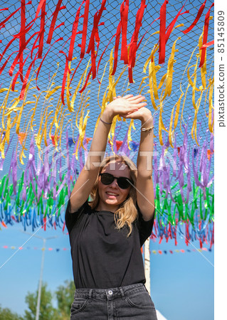 Young woman on festival. Gen z girl enjoying outdoors, expressing positive emotions having fun in park. Millennial generation lifestyle. Young woman on festival. Gen z girl enjoying outdoors, expressing positive emotions having fun in park. Millennial generation lifestyle. 85145809