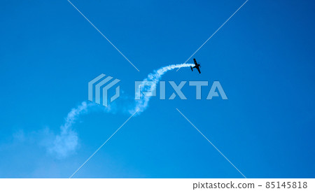 Overhead flying aircraft. Aircraft in formation during an aerobatics display as they loop and roll through the sky. Plane engine failure. Falling airplane crashes 85145818