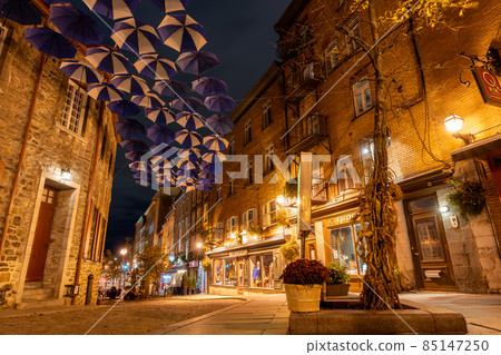Quebec, Canada - October 18 2021 : Umbrella Alley. Quebec City Old Town street view in autumn night. 85147250