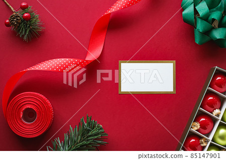 Holiday brand identity design and Christmas flatlay concept. White blank business card and xmas ornament and decoration on red paper background as flat lay mockup Holiday brand identity design and Christmas flatlay concept. White blank business card and xmas ornament and decoration on red paper background as flat lay mockup 85147901