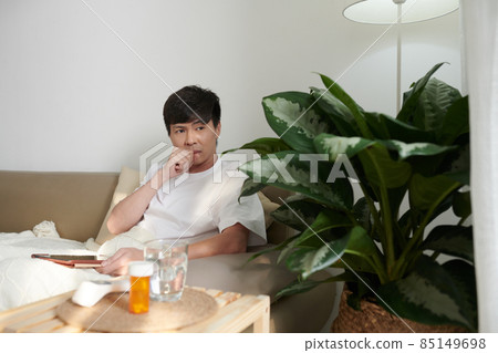Sick Man Using Telemedine Application Sick Man Using Telemedine Application 85149698
