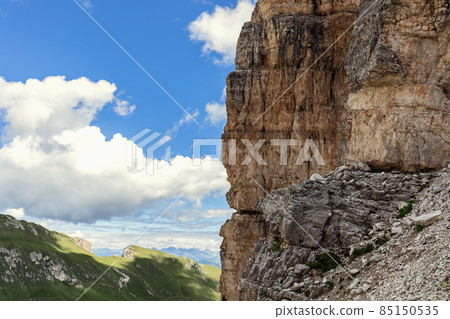 A steep cliff in the Italian Dolomites with the characteristic structure and color of the rock A steep cliff in the Italian Dolomites with the characteristic structure and color of the rock 85150535