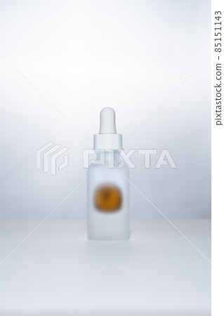 Light backlit face serum in matte bottle with orange Light backlit face serum in matte bottle with orange 85151143