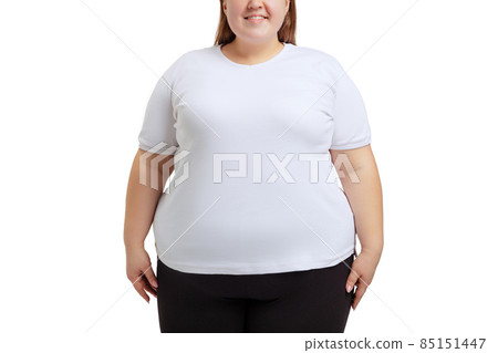 Cropped image of plus-size woman wearing white t-shirt and jeans posing isolated on white studio background. Cropped image of plus-size woman wearing white t-shirt and jeans posing isolated on white studio background. 85151447