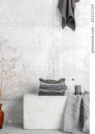 Organic waffle linen towels, bamboo toothbrushes, bathroom zero waste accessories in grey shades in contemporary bathroom interior. Daily body care, spa and wellness zero waste bathroom concept 85152724