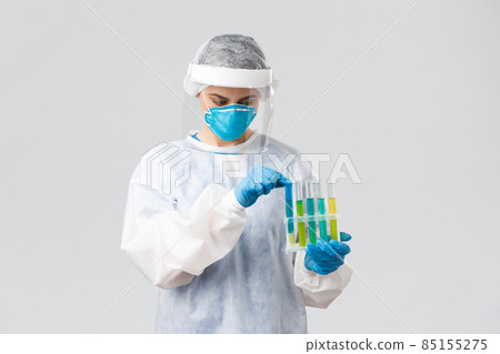 Covid-19, medical research, diagnosis, healthcare workers and quarantine concept. Doctor work clinical lab, test-tubes coronavirus vaccine samples, holding ampoules, wear personal protective suit Covid-19, medical research, diagnosis, healthcare workers and quarantine concept. Doctor work clinical lab, test-tubes coronavirus vaccine samples, holding ampoules, wear personal protective suit 85155275