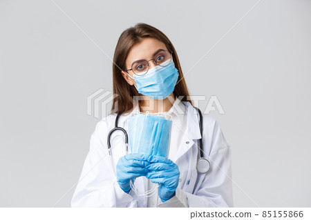 Covid-19, preventing virus, health, healthcare workers and quarantine concept. Professional doctor, physician in personal protective equipment recommend use medical masks, wear scrubs Covid-19, preventing virus, health, healthcare workers and quarantine concept. Professional doctor, physician in personal protective equipment recommend use medical masks, wear scrubs 85155866