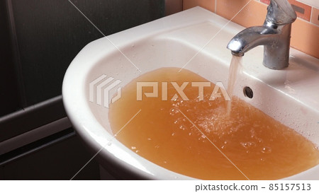 Rusty Water Pours From Tap. Water Pollution. Global Environment 85157513