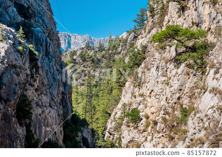 power transmission line was laid in a mountain gorge with steep limestone slopes power transmission line was laid in a mountain gorge with steep limestone slopes 85157872