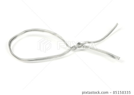 White plastic coated wire tie used for a variety of things on white background. 85158335