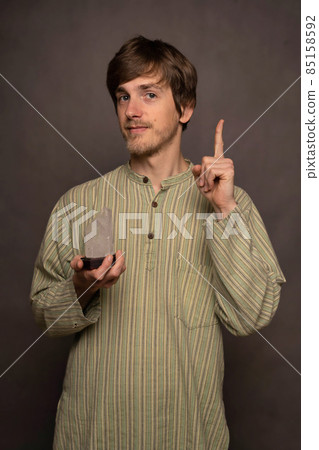 Man holding crystal on grey background 85158592