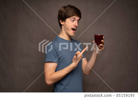 Young white man on grey background Young white man on grey background 85159195