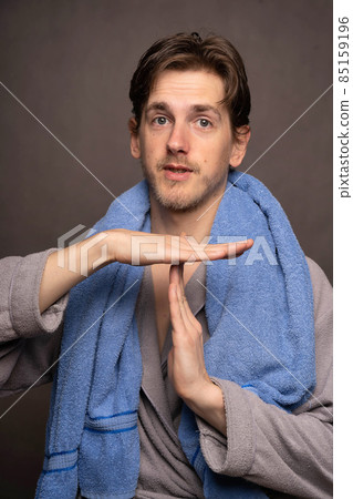 Man with bath towel on grey background Man with bath towel on grey background 85159196
