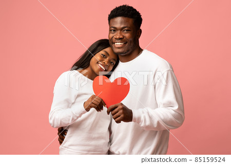 Happy african american couple celebrating love, pink background Happy african american couple celebrating love, pink background 85159524
