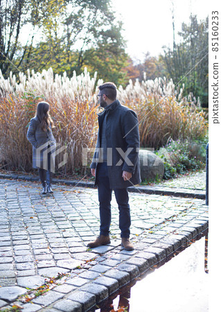 Young man and woman in park Young man and woman in park 85160233