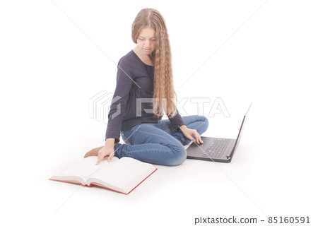 Student teenage girl sitting sideways on the floor with laptop Student teenage girl sitting sideways on the floor with laptop 85160591