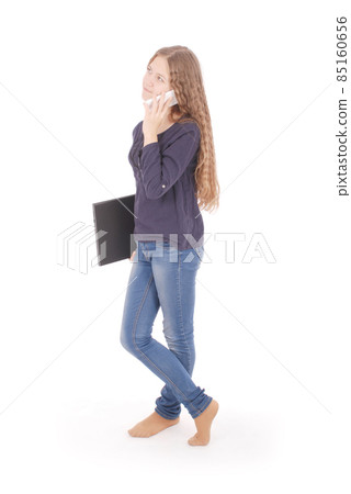 Girl lying sideways on the floor with laptop and smartphone 85160656