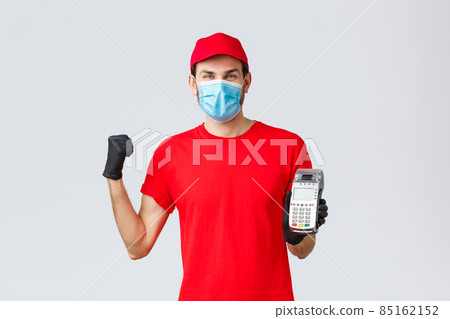 Contactless delivery, payment and online shopping during covid-19, self-quarantine. Rejoicing smiling courier encourage clients pay for order with POS terminal and credit cards, fist pump 85162152