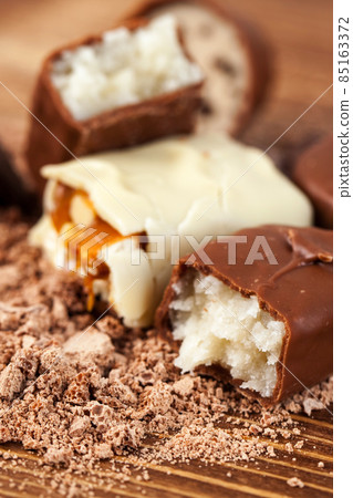 Various yummy chocolate candies on wooden table, sweets Various yummy chocolate candies on wooden table, sweets 85163372