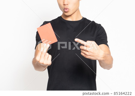 A man wearing a black T-shirt standing in front of a white background and showing a red card 85164222