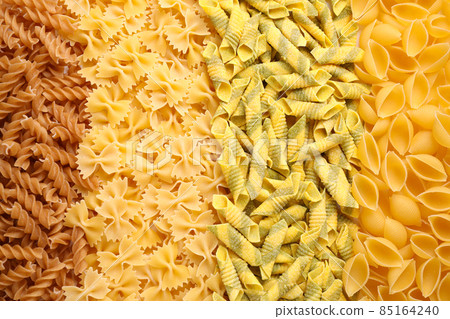 Different types of pasta as background, top view 85164240