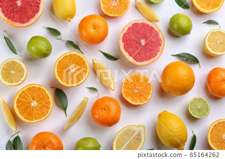 Flat lay composition with tangerines and different citrus fruits on white background 85164262