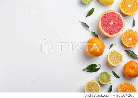 Flat lay composition with tangerines and different citrus fruits on white background. Space for text 85164263