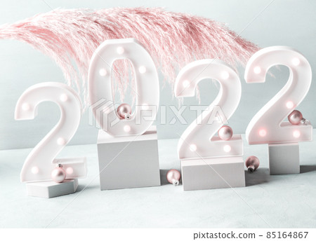 New year 2022 lights numbers with pink pampas branch, podiums New year 2022 lights numbers with pink pampas branch, podiums 85164867