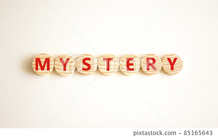 Mystery symbol. The concept word Mystery on wooden circles. Beautiful white background, copy space. Business and mystery mysterious concept. 85165643