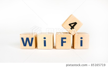 WiFi 4 symbol. The concept word WiFi 4 on wooden cubes. Beautiful white table, white background, copy space. Business, technology and WiFi 4 or WiFi4 concept. WiFi 4 symbol. The concept word WiFi 4 on wooden cubes. Beautiful white table, white background, copy space. Business, technology and WiFi 4 or WiFi4 concept. 85165719