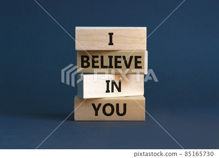 I believe in you symbol. Concept words 'I believe in you' on wooden blocks on a beautiful grey background. Businessman hand. Business, religion and i believe in you concept. 85165730