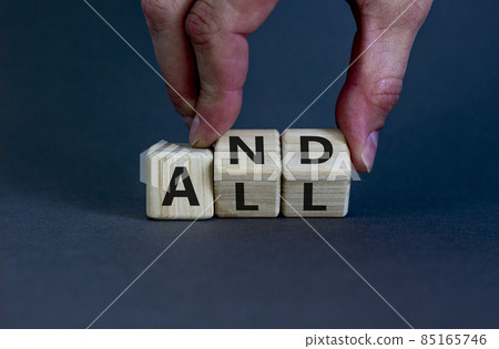 And all symbol. Businessman turns wooden cubes with words 'And all'. Beautiful grey background. Business, popular quotes and all concept. Copy space. 85165746