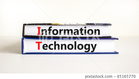 IT, information technology symbol. Concept words 'IT, information technology' on books on a beautiful white table, white background. Business, IT, information technology concept, copy space. IT, information technology symbol. Concept words 'IT, information technology' on books on a beautiful white table, white background. Business, IT, information technology concept, copy space. 85165770
