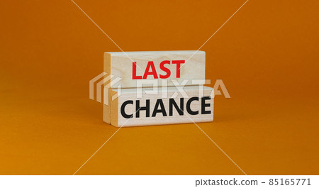 Time to last chance symbol. Concept words Last chance on wooden blocks on a beautiful orange background. Business and time to last chance concept. Copy space. Time to last chance symbol. Concept words Last chance on wooden blocks on a beautiful orange background. Business and time to last chance concept. Copy space. 85165771