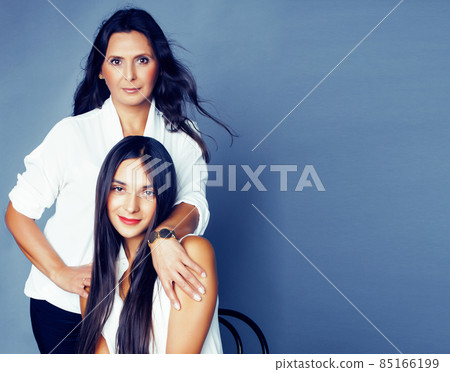 cute pretty teen daughter with mature mother hugging, fashion style brunette, lifestyle people concept cute pretty teen daughter with mature mother hugging, fashion style brunette, lifestyle people concept 85166199