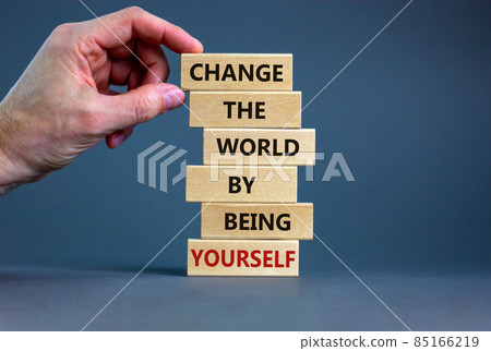 Change the world by being yourself symbol. Wooden blocks with words Change the world by being yourself. Businessman hand. Beautiful grey background. Business, popular quotation concept. Copy space. Change the world by being yourself symbol. Wooden blocks with words Change the world by being yourself. Businessman hand. Beautiful grey background. Business, popular quotation concept. Copy space. 85166219