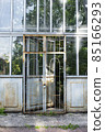 Vintage glass door of the greenhouse. Saint Petersburg city park. 85166293