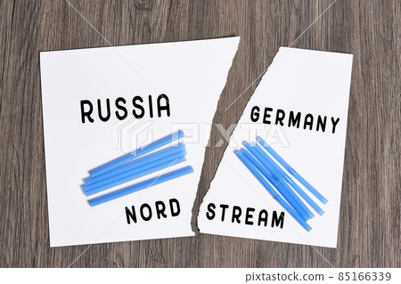 Plastic straws on Russian and German national flags. Nord Stream gas pipeline, sanctions and politics. Russia Vs Germany. Torn paper. Plastic straws on Russian and German national flags. Nord Stream gas pipeline, sanctions and politics. Russia Vs Germany. Torn paper. 85166339