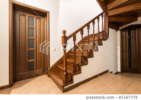 Modern brown oak wooden stairs and doors in new renovated house interior 85167778