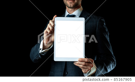 Screen mockup. Empty blank tablet in businessman hand. Mock up screen smart device isolated on black banner background. Game design, mobile application presentation or portfolio mockups. Screen mockup. Empty blank tablet in businessman hand. Mock up screen smart device isolated on black banner background. Game design, mobile application presentation or portfolio mockups. 85167905