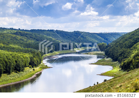 Green valley in summer with forests on hills and big river below Green valley in summer with forests on hills and big river below 85168327