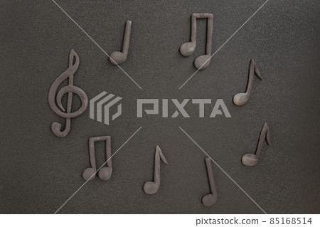 Treble clef and music notes on black background. Music symbol. Key of G. Violin key. Musical notation. Copy space. Treble clef and music notes on black background. Music symbol. Key of G. Violin key. Musical notation. Copy space. 85168514